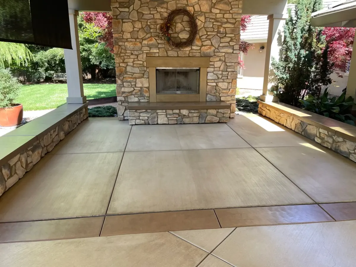 Stamped concrete patio with a fireplace